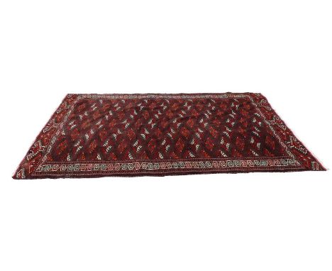 A kilim rug, 20th century, the dark maroon ground with a repeating geometric pattern,345 x 203cmCondition ReportCollection of