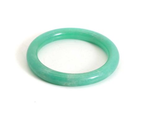 A Chinese jadeite bangle, 20th century, of circular cross-section form with a polished finish, medium green, vitreous lustre,