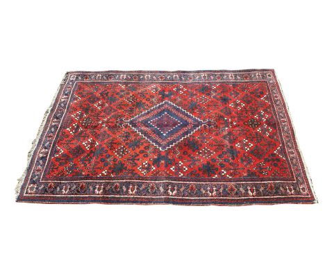 A Qashqai rug, 20th century, central lozenge to a red feild within a scrolling multi border,203 x 133cmCondition ReportSlight