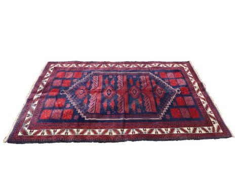 A Baluch wool rug, 20th century, with stylished motifs to a navy ground, within a multi border with ivory centre,263 x 167cmC