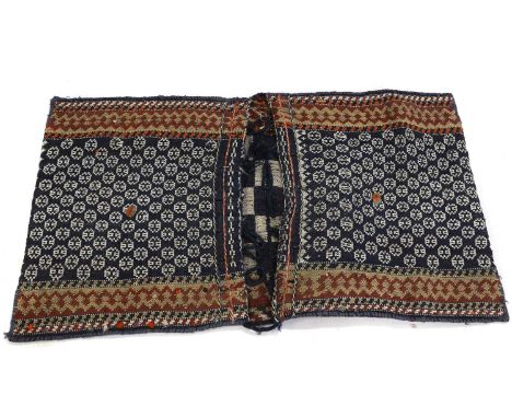 A Qashqai double saddle bag, 20th century, with repeating geometric motifs to a dark blue ground, the interior with monochrom