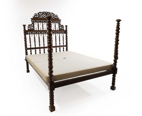 A large Anglo Indian mahogany bed,  late 19th century, with carved scrolling headboard, 145cm wide 210cm deep 179cm high Prov