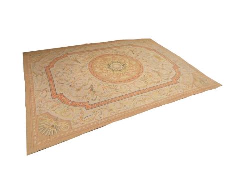 An Abusson style flatweave carpet, 19th/20th century, centred with a shaped foliate medallion decorated with a bouquet of flo