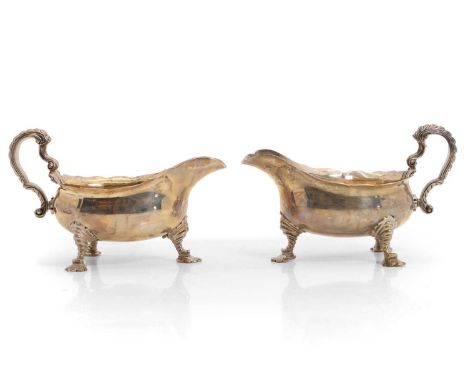 A pair of George II style silver sauceboats, by Mappin &amp; Webb, London 1933, each with a scrolled handle and gilt interior