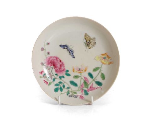 A Chinese famille rose saucer, of circular form, decorated with butterflies among blossoming flowers, 15.4cm diameterConditio
