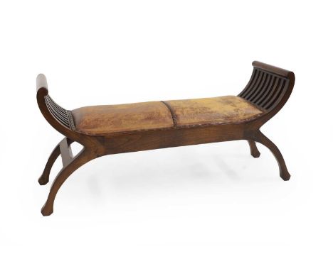 A 20th century 'X' framed stool,  the seat upholstered with brown leather,  121cm wide 35.5cm deep 60cm high Provenance: The 