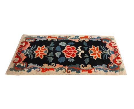 A Tibetan rug, large pattern in cream, orange, dark blue cotton backing,183 x 164Provenance: purchased from a village on the 
