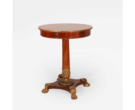 A mahogany lamp table, 19th century, with a circular top, with a single frieze drawer, on a turned column, with gilt details 