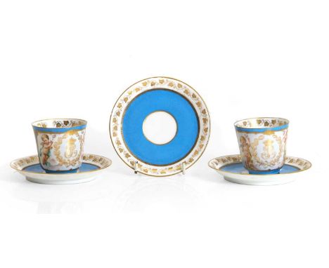 A pair of Sèvres-style porcelain cups and saucers, 19th century, painted with putti flanking crowned LP monogram for Louis-Ph