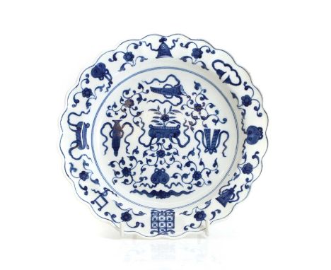 A First Period Worcester porcelain 'Hundred Antiques' pattern dish, c.1770, with scalloped edge, decorated with flowerheads a