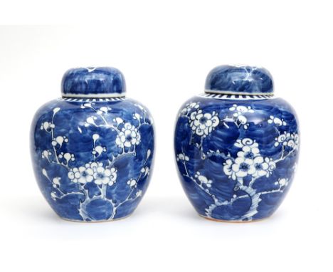 pair of Chinese lidded ginger jars in porcelain with a blue-white blosoms decor || Paar Chinese gedekselde gemberpotten in po