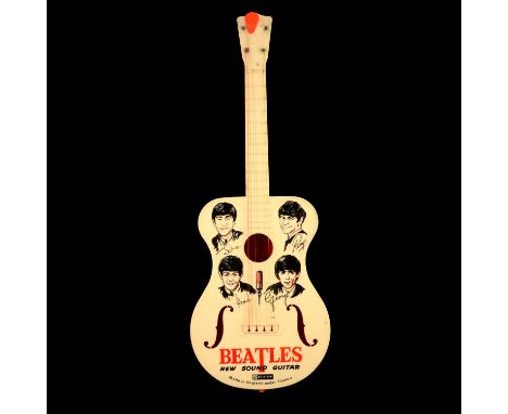 Selcol toy guitar 'The Beatles New Sound Guitar', with illustrated front of the band, 58cm, with orange plectrum.