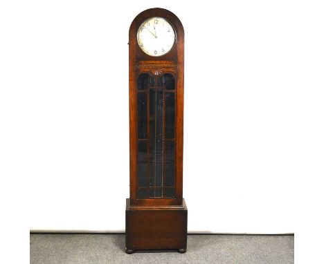 1940's oak longcase clock, domed top, glaze door, bun feet, triple weight movement striking on eight gongs, height 191cm.