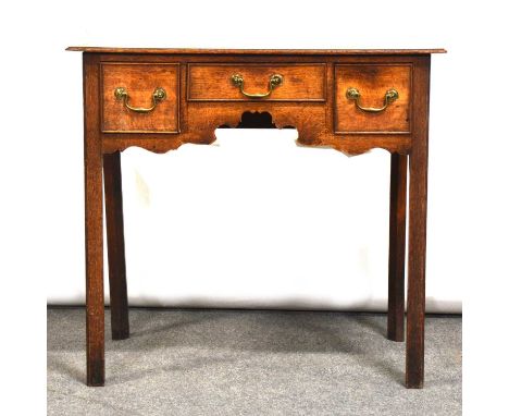 George III oak and mahogany lowboy, the top with crossbanding and moulded edge, three drawers abov ea shaped apron, moulded l