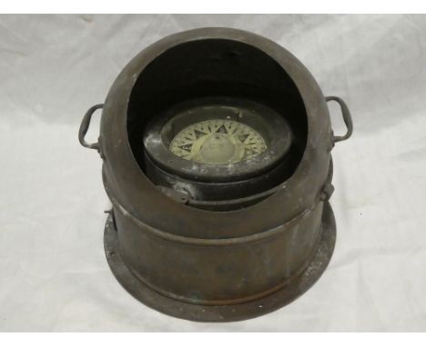A copper ship's liquid binnacle compass with circular dial and cover
