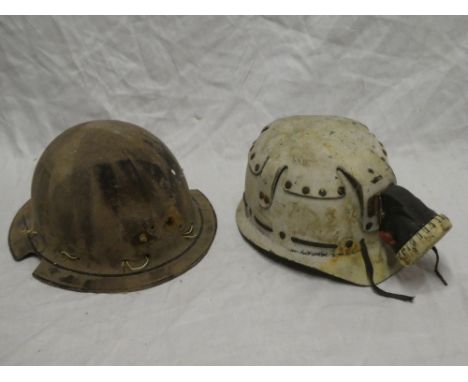 A fibre miner's helmet with brim and one other similar miner's helmet with cap lamp (2)