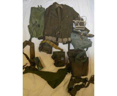 A Second War US Army females Khaki tunic, a selection of US wartime and post-war belts and military kit, water bottle, brass 