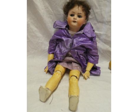 A child's porcelain headed doll by Heubach Koppelsdorf of Germany marked "250.8" with composition jointed body, 29" long