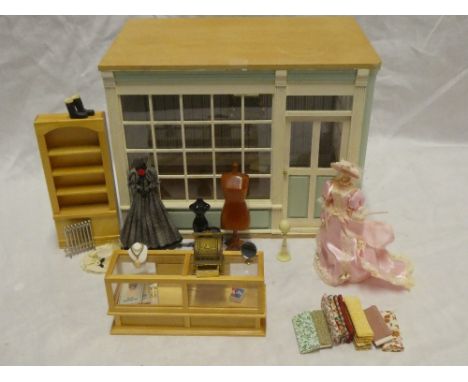 A doll's 1/12th shop setting fitted with shop counter, displays, clothing and mannequin, etc