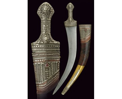 dating: 19th Century provenance: Oman, Long, curved, double-edged blade of almost-flat section. Silver grip, decorated with f