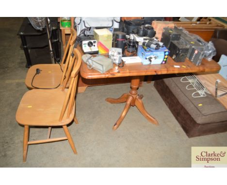 A pine drop leaf table and a pair of stick back chairs