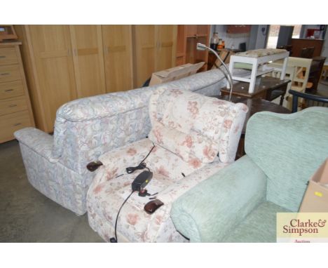 A rise and recline upholstered armchair with adjustable reading light