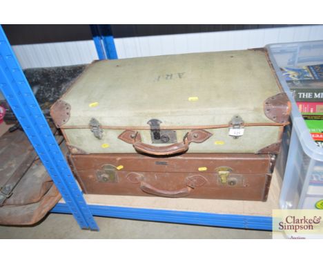 A leather bound canvas trunk together with one other