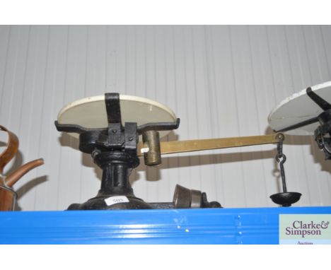 A set of cast iron and brass counter scales with ceramicplatform