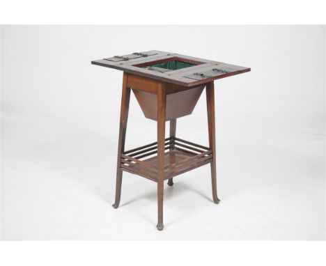 An Edwardian inlaid mahogany sewing table
The rectangular hinged top inlaid with satinwood spandrels enclosing leather insets