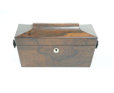 A George IV rosewood sarcophagus tea caddy
Enclosing two lidded compartments, turned side handles 13x30x15cms