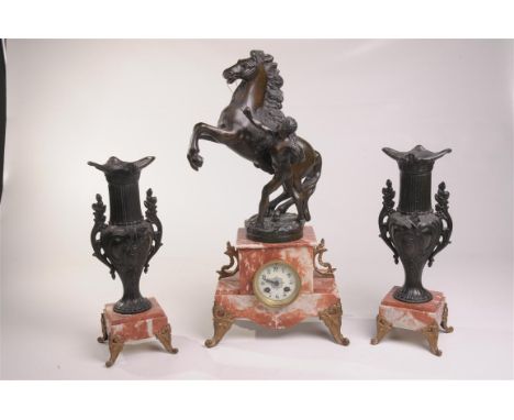 A rouge marble gilt metal animalier clock garniture
With a 7cm white dial with Arabic numerals the two train movement with ou