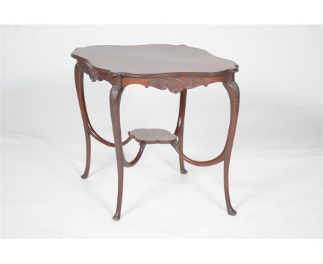 A Victorian mahogany occasional table 
of shaped oval form with a moulded border, leaf and shell frieze raised upon curviline