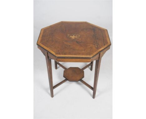 An Edwardian inlaid rosewood octagonal centre table
Centred with a classical urn with pendant leaves raised upon four slender