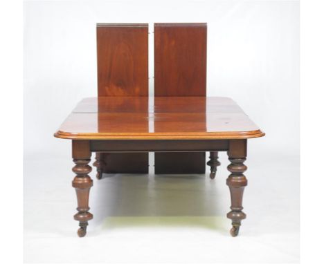 A Victorian mahogany extending dining table
The rectangular moulded top with rounded angles enclosing two extra leaves above 