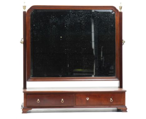 A 19th Century mahogany toilet mirror
The rectangular moulded frame with re-entrent angles enclosed by fluted uprights with b