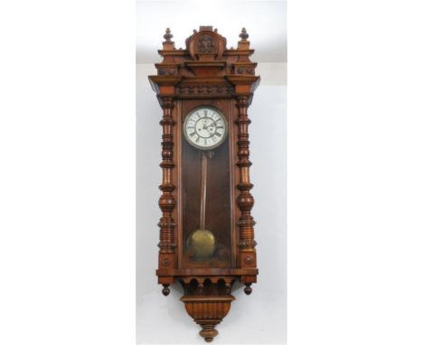 A Vienna style walnut veneered and beechwood wall clock, late 19th Century
With a 18cm white dial with Roman numerals, and su