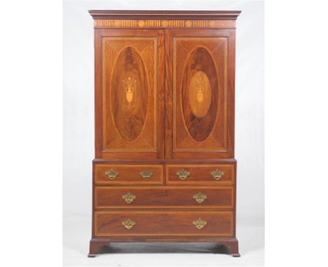 A fine 19th century inlaid mahogany gentleman's clothes press
With a cavetto cornice above a frieze inlaid with roundels encl