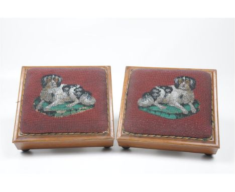 A pair of Victorian Berlin work hound footstools
Each of rectangular form with a raised padded Berlin work panel depicting a 