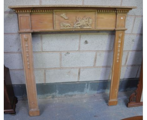 A 19th Century Adams style pine fireplace
The rectangular shelf with a gesso border above a tablet applied with classical fig