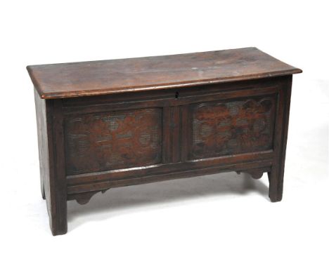 A late 18th Century oak coffer
The rectangular one piece plank top above a channelled frieze indistinctly carved with initial