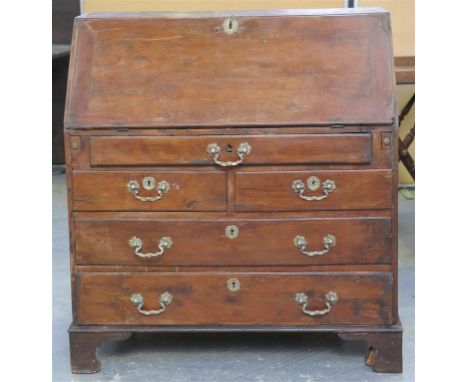 An 18th Century yew wood bureau
The rectangular hinged fall front enclosing a well fitted interior with a frieze drawer above