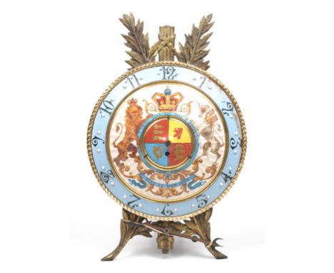 An unusual erthenware and gilt metal commemorative easel clock
With a 35cm convex dial with Arabic numerals, the centre with 