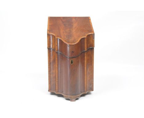 A George III inlaid mahogany serpentine cutlery box
The hinged cover with an interior inlaid with an oval shell, later fitted