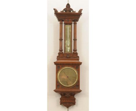 A Victorian walnut cased barometer
With a 11cm brass dial signed Negretti and Zambra, London, No: 11027 above a thermometer, 