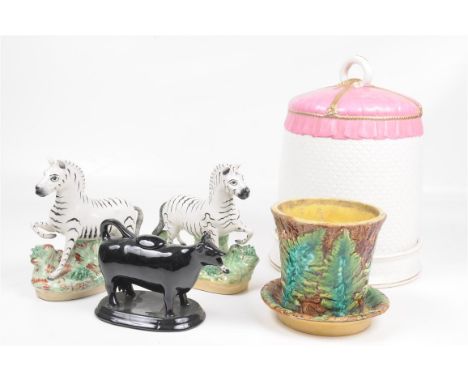 A pair of Victorian Staffordshire zebras
Standing four square raised upon a naturalistic bocage encrusted oval base 19cms hig