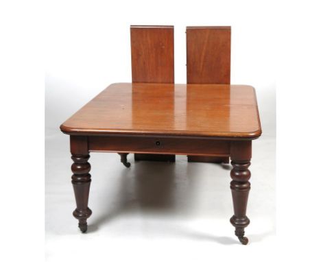 A mid 19th Century mahogany extending dining table
With a rectangular moulded top enclosing two leaves above a plain frieze, 