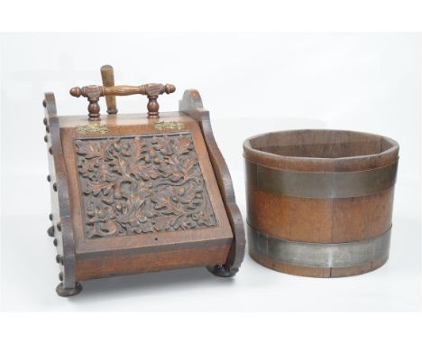A Victorian oak and brass coal purdonium
Of wedge shape, the hinged fall front carved with fruiting oak leaves and acorns, ti