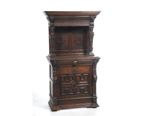 A Victorian carved oak sideboard
In the Jacobean style with a cavetto cornice above a leaf gadroon and scale frieze, a pair o