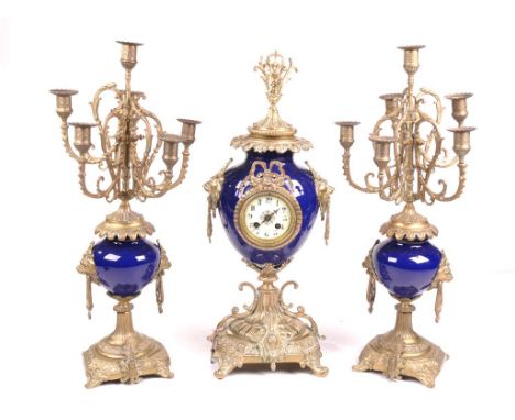 A French gilt brass and porcelain clock garniture
With a white dial with Arabic numerals, the two train A.D. Mougin movement 