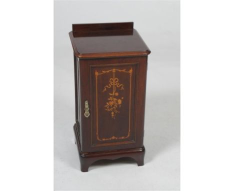 A pretty Victorian and marquetry inlaid bedside cupboard
With a rectangular moulded top above a panelled cupboard door finely